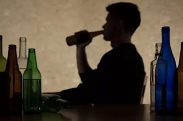 A man consumes alcohol